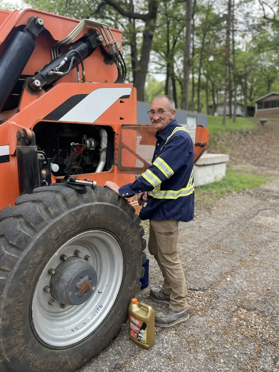 Tulsa Fleet Repair technician repairing a boom lift engine on-site